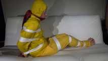 Watching Pia wearing a sexy yellow rainwear being tied and gagged with tape and a ballgag on a sofa (Video)