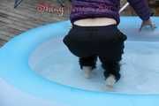 Watching sexy Sonja wearing a supersexy black rain pants and a purple down jacket taking a bath in the swimming pool (Pics)