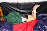 Samantha tied and gagged in bed wearing a black shiny nylon shorts and a green rainjacket (Pics)