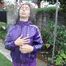 Watching sexy Aiyana wearing a sexy purple shiny nylon shorts and a purple shiny nylon rain jacket enjoying the garden shower (Pics)