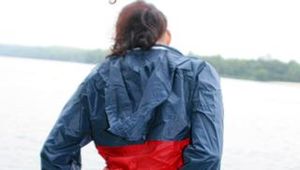Sexy archive girl walking on a lake wearing a sexy shiny nylon shorts and an oldschool rain jacket (Pics)