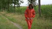 Miss Petra takes a walk in a orange AGU rain suit and rubber boots