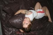 Katharina lolling in a bed covered with shiny nylon duvet cover wearing a sexy white shiny nylon shorts and a top (Pics) 