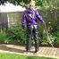 Watching sexy Sandra wearing a sexy blue rain pants and a purple rain jacket watering the flowers in the garden (Video)