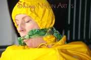 Watching sexy Pia being tied and gagged with ropes on a bed and a clothgag wearing sexy yellow shiny nylon rainwear (Pics)