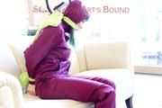 Mara tied and gagged with cloths on a sofa wearing a sexy purple shiny nylon rainwear (Pics)