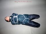 One of our archive girls tied and gagged in shiny nylon rainwear