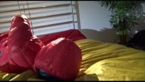 Jill tied, gagged and double-hooded on a bed wearing sexy shiny nylon rain pants and a down jacket (Video)