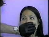 24 Yr OLD VIETNAMESE DAISY IS CLEAVE GAGGED, BAREFOOT, MOUTH STUFFED WITH NYLON ANKLE STOCKING, STUFFS HER OWN MOUTH, TIED ON BED & HANDGAGGED WITH BLACK LEATHER GLOVE (D55-5)