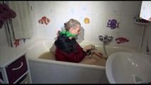 Mara sitting in her bathtub wearing a sexy shiny nylon shorts and a rain jacket while bounding herself (Video)