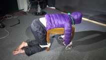 Watching Sonja wearig a sexy blue rainpant and a purple down jacket being tied, gagged and hooded on a stool with ropes and a cloth gag (Video)