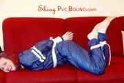 Mara tied and gagged on a sofa wearing a shiny blue PVC sauna suit (Pics)