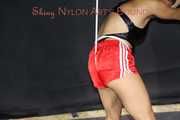 Sexy Sandra being tied and gagged overhead wearing a sexy red shiny nylon shorts and a black swimsuit (Pics)