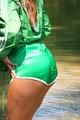 Stella wearing a supersexy green shiny nylon shorts and a green rain jacket as well as green rubber boots while jumping in puddles (Pics)