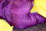 Lucy wearing a supersexy purple rain suit with hood while preparing her bed (Pics)