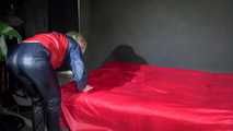 Watching Sonja wearing supersexy red/blue shiny nylon rainwear preparing her bed with shiny nylon cloth (Video)