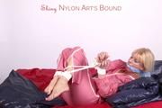 Pia tied and gagged in a beautiful rose shiny nylon rainsuit in bed (Pics)