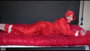 *** HOT HOT HOT*** NEW MODELL*** DESTINY wearing a new sexy red shiny nylon rain suit tied and gagged on bed with ropes and a cloth gag (Video)