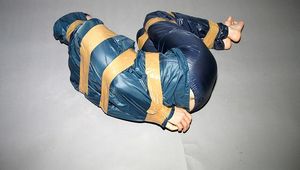 One of our archive girls tied and gagged in shiny nylon rainwear