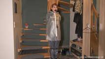 Miss Lara in nylon rain suit and transparent rain gear is bound and gagged