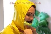 Jill tied, gagged and hooded on a stairway wearing a sexy shiny yellow rainwear combination (Pics)