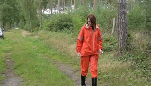 Miss Petra takes a walk in a orange AGU rain suit and rubber boots