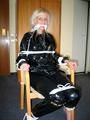 One of our archive girls tied and gagged in a shiny black PVC saunasuit