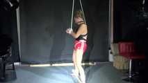 Sandra being tied and gagged overhead and on a bar wearing a sexy black swimmsuit and a red shiny nylon shorts (Video)