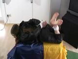 Archive girl tied and gagged wearing a shiny nylon rainwear (Video)