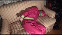 Mara tied and gagged with cloths on a sofa wearing sexy pink shiny nylon rainwear (Video)