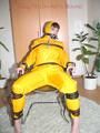 Jill tied, gagged and hooded with a tension belt on a chair wearing a supersexy yellow shiny nylon rainpants and rain jacket (Pics)