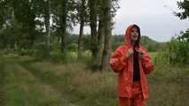 Miss Petra takes a walk in a orange AGU rain suit and rubber boots