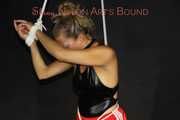 Sexy Sandra being tied and gagged overhead wearing a sexy red shiny nylon shorts and a black swimsuit (Pics)