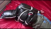 Jill tied, gagged and hooded on bed wearing a sexy shiny black downjacket with a closed hood (Video)