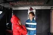 SEXY RONJA wearing shiny nylon downwear being tied and hooded with tapes from Stella on a rack (Pics)