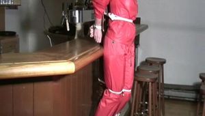 one of our archive girl tied and gagged in a shiny nylon rainsuit