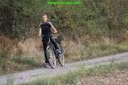 Watch Sandra riding and checking her Bike wearing a shiny nylon Jumpsuit