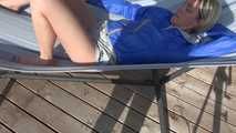 Watching sexy Sonja wearing a grey shiny nylon shorts and a blue rainjacket enjoying the sun (Video)