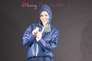 Mara posing in the studio wearing a blue rain skirt and a blue rain jacket as wellas red rubber boots (Pics)