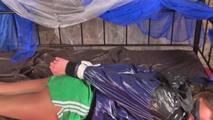 Alina tied and gagged in a princess bed standing in an old cellar wearing hot shiny nylon shorts and rainjacket (Video)