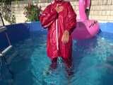 Watch Sandra watering the garden and wetting her shiny nylon oldschool Rainsuit in the Pool