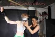***RONJA*** being tied and gagged overhead with ropes and a special combination of nylon over head and tape gagg from STELLA both wearing sexy shiny nylon shorts and tops (Pics)