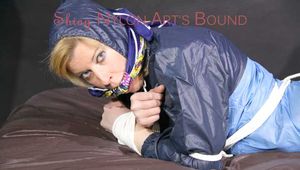 PIA tied with ropes on the sofa, gagged with a cloth gag wearing a sexy blue oldschool shiny nylon rain suit (Pics)