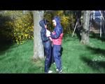 Jill and a friend of her playing with eachother in the garden while wearing shiny nylon rainwear (Video)