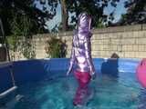 Watch Sandra enjoying her shiny nylon Downwear at a warm Summer Day in the Garden and in the Pool