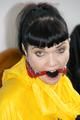 Jill tied and gagged on a chair wearing a yellow rainsuit and coveres with an yellow raincoat with two hoods (Pics)