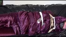 Lucy tied, gagged and hooded on the sofa wearing a sexy purple shiny nylon downwear combination (Video)