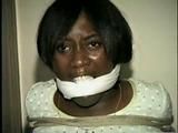 BLACK BANK TELLER IS MOUTH STUFFED, CLEAVE GAGGED & ROPE TIED TO CHAIR  (D46-2)