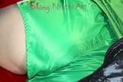 Lucy wearing sexy green shiny nylon shorts and a green rain jacket lolling on bed with a special cover (Pics)
