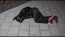 Jill tied, gagged and hooded on a cellar floor wearing a shiny green rain pants and a shiny black down jacket (Video)